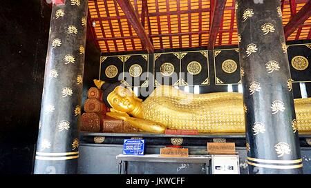 Golden reclining Buddha image statue in Thai temple in Chiang Mai, Thailand. Stock Photo