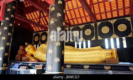 Golden reclining Buddha image statue in Thai temple in Chiang Mai, Thailand. Stock Photo