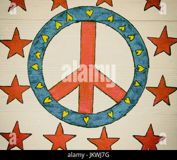 Retro hand painted peace symbol on wood panel background Stock Photo