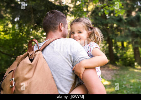 Unrecognizable father with little daughter going camping in fore Stock Photo