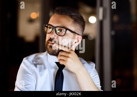 Businessman in the office working at night. Stock Photo