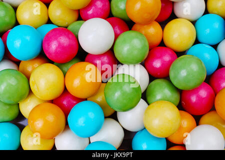 Bubble gum chewing gum texture. Rainbow multicolored gumballs chewing gums as background. Round sugar coated candy dragee bubblegum texture. Food cute Stock Photo