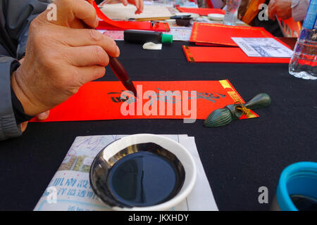 HONG KONG, CHINA - JANUARY 26, 2017: Chinese calligraphy on red paper contain meaning for Chinese New Year wishes Stock Photo