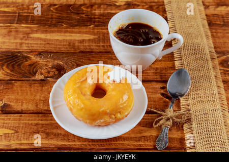 Colorful Donuts breakfast composition with different color styles of doughnuts over an aged wooden desk background. Stock Photo