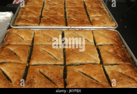 Spanakopita, also known as Spinach pie, a baked savory Greek dish made with phyllo pastry, layered with spinach and feta cheese on a baking tray Stock Photo