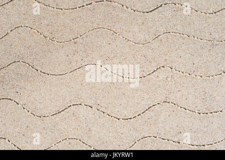 wave pattern drawing in sand background Stock Photo