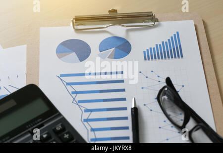 Checking financial reports paperwork and Business  Teamwork on Preparing report Blue graphs  glasses Stock Photo