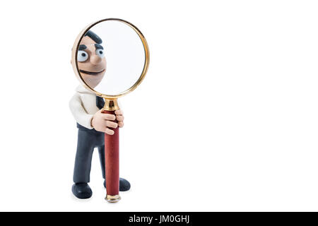 Plasticine businessman holds a magnifying glass in hands, isolated on a white background Stock Photo