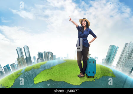 Happy asian woman tourist wearing hat looking something against futuristic background Stock Photo