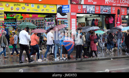 Pix shows: Wet summer in London. Rain battered shopper in Oxford Street near John Lewis store.     Pic by Gavin Rodgers/Pixel 8000 Ltd Stock Photo