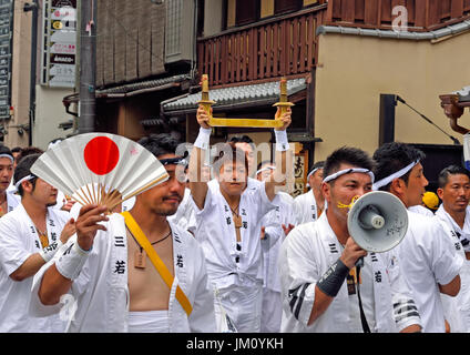 KYOTO, JAPAN - July 24, 2017: A group of men parade down a street in Kyoto, Japan during the Gion Matsuri. Stock Photo