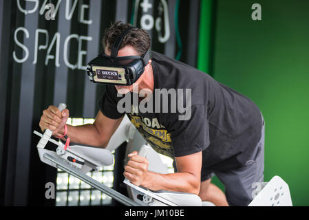 BONTIDA, ROMANIA - JULY 14, 2017: A guy using Samsung virtual reality headset. Man playing with a VR oculus googles at Electric Castle festival tech z Stock Photo