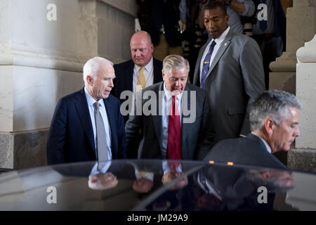 Washington, USA. 25th July, 2017. U.S. Senator John McCain (L) leaves after voting on Capitol in Washington, DC, the United States, on July 25, 2017. The U.S. Senate on Tuesday voted 51-50 to begin a debate on proposals to end Obamacare, as Republicans rallied again to fulfill their seven-year-long promise. Credit: Ting Shen/Xinhua/Alamy Live News Stock Photo