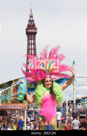 Attractive young woman wearing feather boa and head dress taking part in the Blackpool international carnival Stock Photo