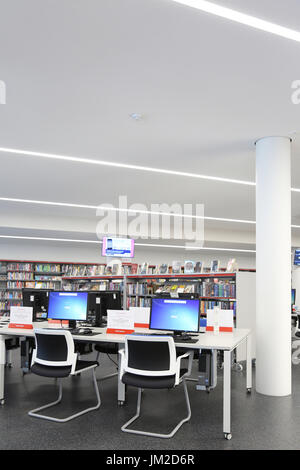 Interior view of the newly rebuilt Marcus Garvey Library in London Borough of Haringey, UK. Shows traditional bookshelves and new computer terminals. Stock Photo