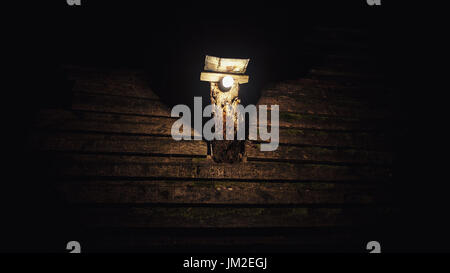 One bulb on old hand crafted pillar, on top of house roof. Stock Photo