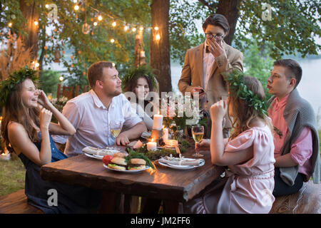 People having dinner in garden Stock Photo