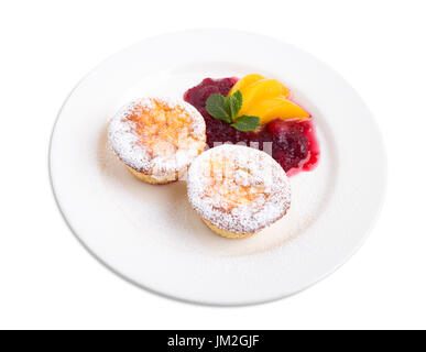 Cheese muffin with cranberry sauce and peaches. Isolated on a white background. Stock Photo