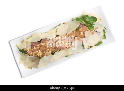 Delicious beef salad with cheese and pine nuts. Isolated on a white background. Stock Photo