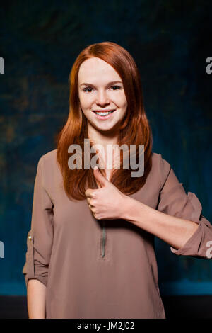 young red-haired showing thumb up Stock Photo