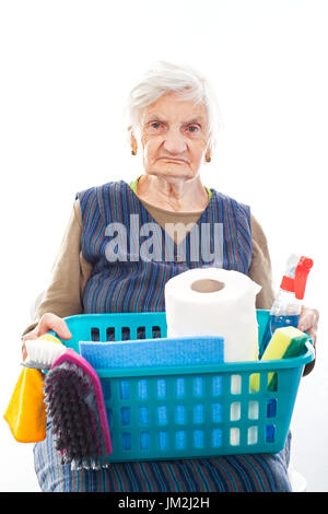 Portrait of a happy senior lady doing housework holding cleaning equipment Stock Photo