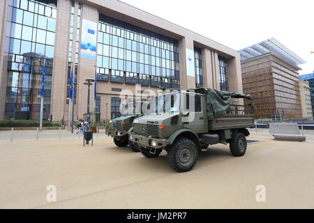 Brussels, Belgium - July 17, 2017: Military trucks opposite European Council building. Army on the streets of Brussels after the terrorist acts. Stock Photo