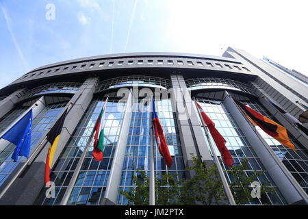 Brussels, Belgium - July 17, 2017: Flags on European Parliament building background. Flags of EU countries opposite facade of European Parliament buil Stock Photo