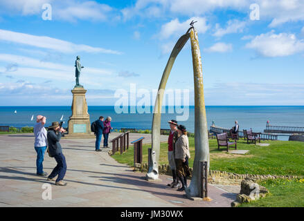 Captain Cook memorial statue and Whale jaw bone arch on West Cliff overlooking town and harbour in Whitby, North Yorkshire, England, UK, Stock Photo