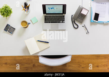 laptop, phone and other office stuff on table Stock Photo