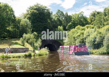 visitors on boat trip at the top of the Falkirk Wheel heading towards the tunnel and the Union Canal Stock Photo