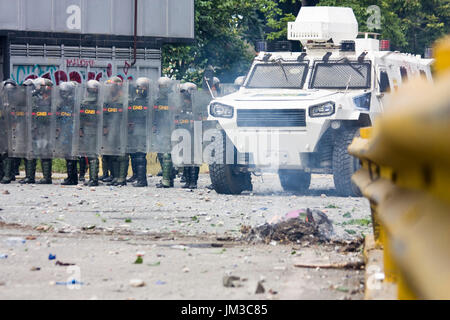 The Bolivarian National Guard confront demonstrators that were blocking a street as a protest against the government of Nicolás Maduro. Stock Photo