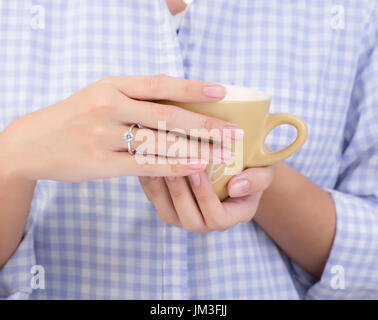 female hands holding a cup of coffee Stock Photo