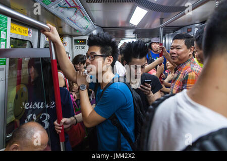 HONG KONG - JULY 17, 2014:  Passengers in the metro car Stock Photo