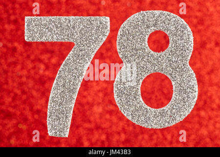 Number seventy-eight silver color over a red background. Anniversary. Birthday Stock Photo