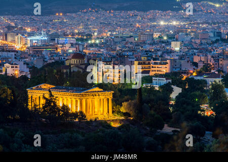 Night view of Temple of Hephaestus and city skyline behind, Athens, Attica, Greece Stock Photo