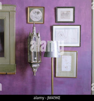 Artwork on purple painted wall Stock Photo
