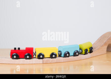 brightly coloured train going on a journey Stock Photo