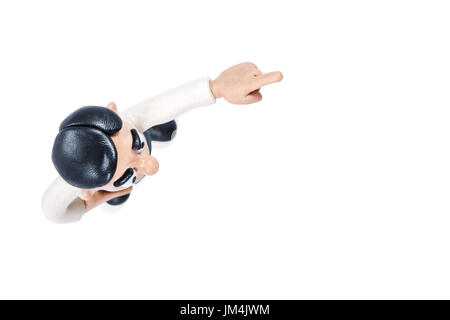 Plasticine man points finger forward, top view, isolated on white background Stock Photo