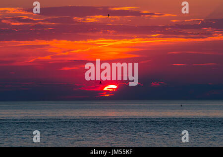 Fiery red sunset over the Atlantic Ocean in Provincetown, MA Stock Photo