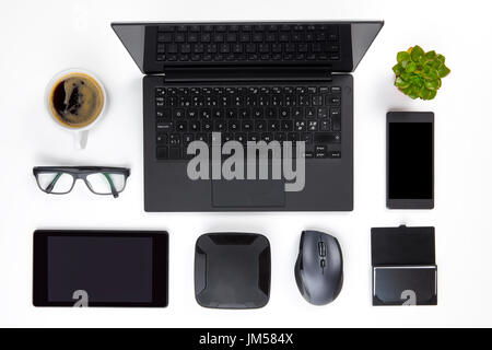 Various Devices Arranged On White Office Desk Stock Photo