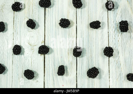 Blackberry are arranged in a row. Flat lay. Berries on a white background. Stock Photo