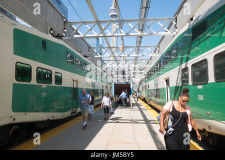 CN Tower viewed fro Union Station between two Go commuter trains in Toronto, Ontario, Canada Stock Photo