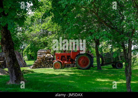 red tractor with wooden trailer parked on a lawn in szatta village vas county hungary Stock Photo