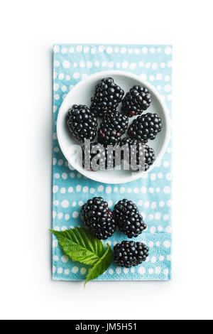 Tasty ripe blackberries in bowl isolated on white background. Stock Photo