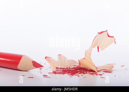 Red just sharpened pencil with shavings on white background with copy space Stock Photo