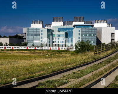 MRC Molecular Biology Lab / Train - A London to Cambridge Train  passes the MRC Laboratory of Molecular Biology, Cambridge UK. Guided busway on right. Stock Photo