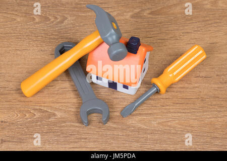 High angle view of a plastic house model and three working tools as concept for construction of residential buildings or home improvement Stock Photo