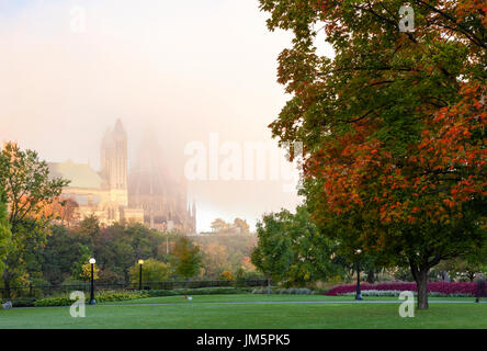 Major's Hill Park with the Ottawa Library of Parliament in the background during a foggy morning in Ottawa, Ontario, Canada. Stock Photo