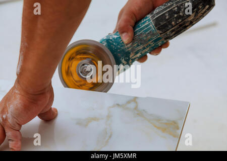 industrial tiler builder worker installing floor tile at repair renovation work Stock Photo