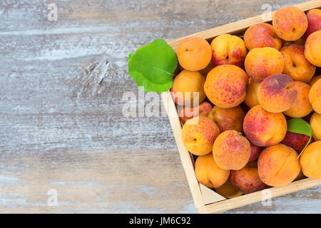 wood box with apricots on a old wooden background Top view Stock Photo